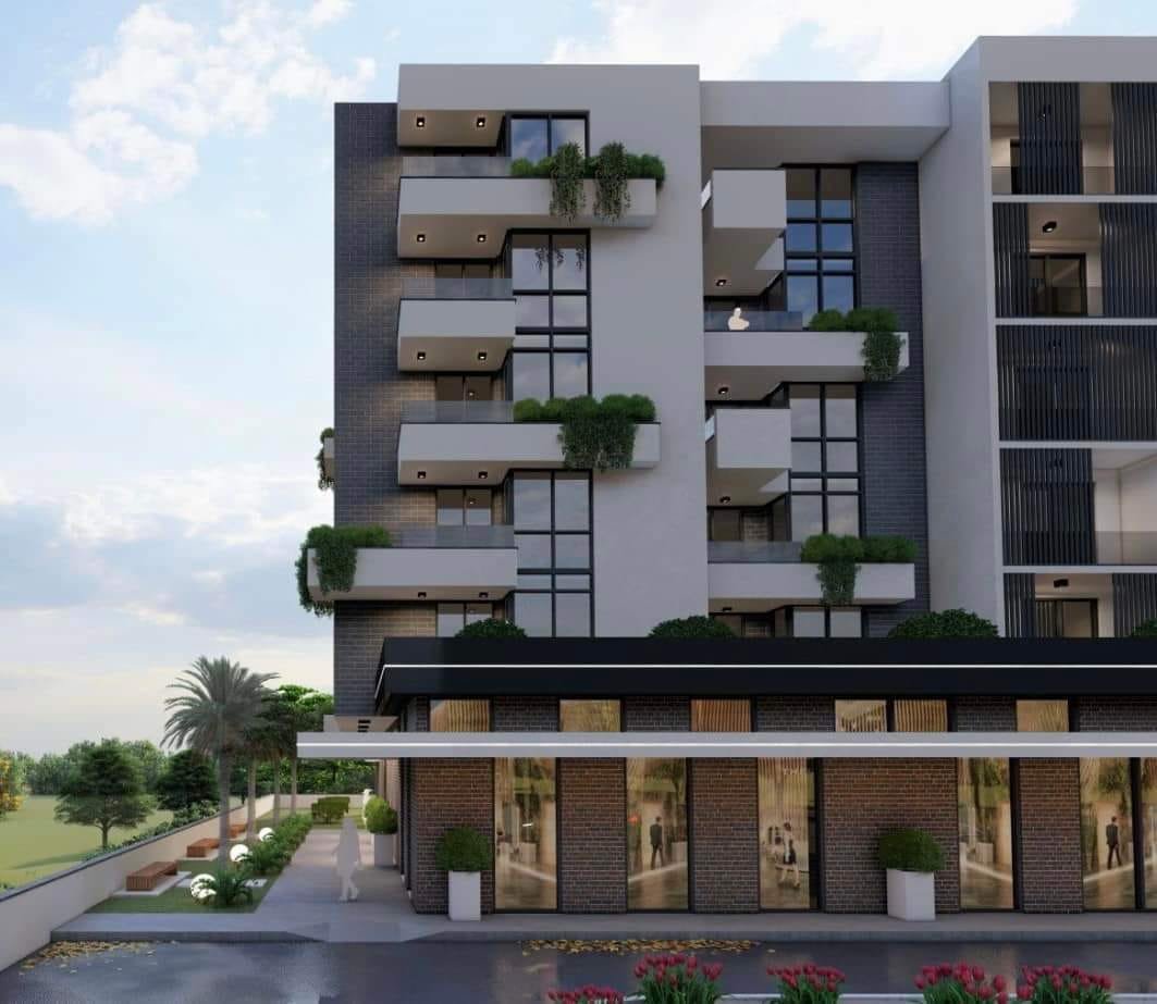 Contemporary multi-story building in Ulcinj with glass balconies, large windows, and premium storefronts&mdash;invest with ekosphere doo.