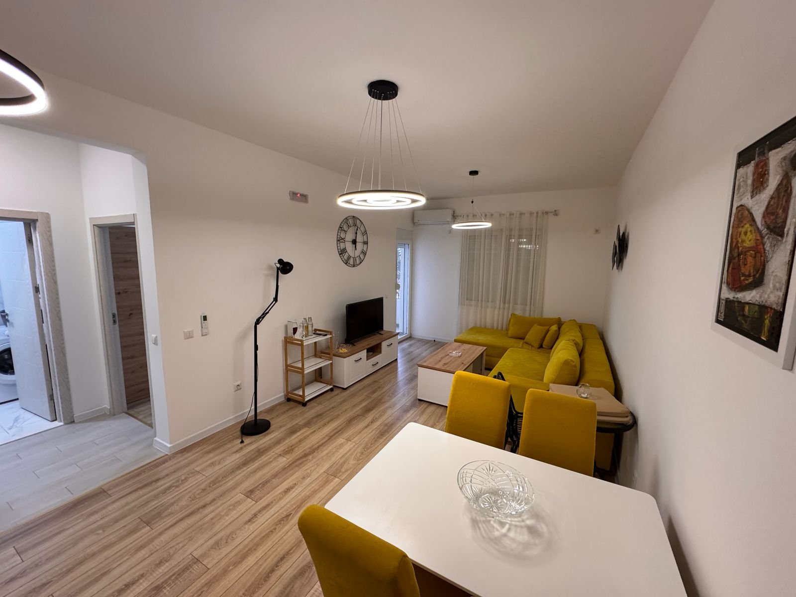 Stylish modern living-dining space in Ulcinj, Montenegro with wood floors, designer sofa&mdash;exclusive on immorenta.me by Ekosphere.