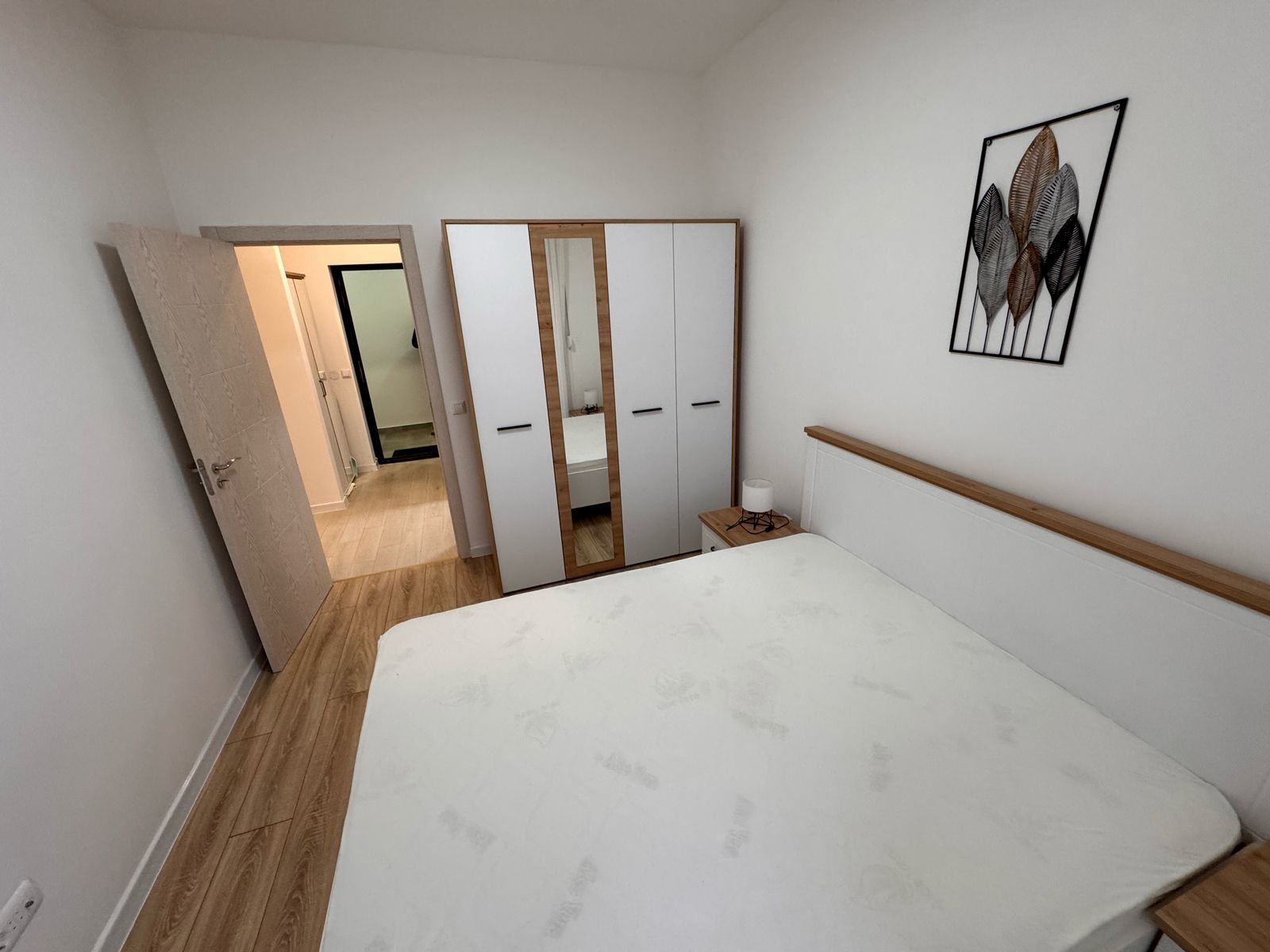 Spacious Ulcinj bedroom with large bed, mirrored wardrobe, wood accents&mdash;exclusive on immorenta.me by ekosphere doo.