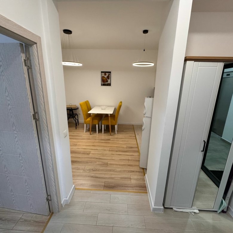 Bright dining area with wood floors, stylish lighting, and modern furnishings&mdash;ideal Ulcinj investment. Listed on immorenta.me by ekosphere doo.