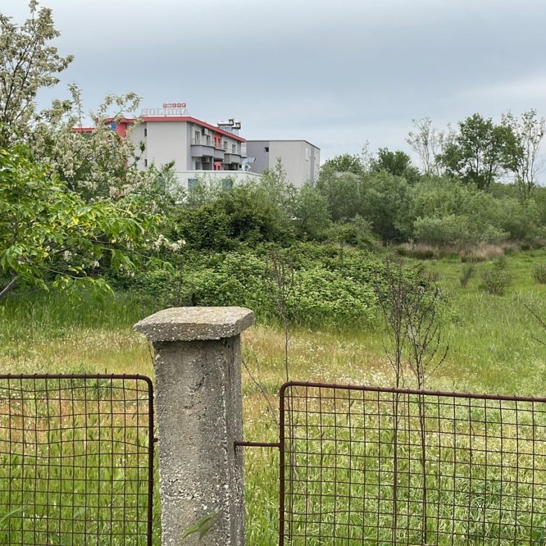 Prime Ulcinj, Montenegro property: lush field, scenic views, modern home with red roof&mdash;exclusive at immorenta.me by Ekosphere doo.