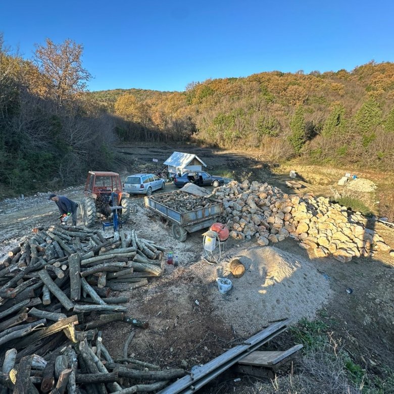 Prime eco-investment land in Ulcinj: spacious, tree-lined plot with work crews, logs, stones, and vehicles&mdash;exclusively at immorenta.me by ekosphere doo.