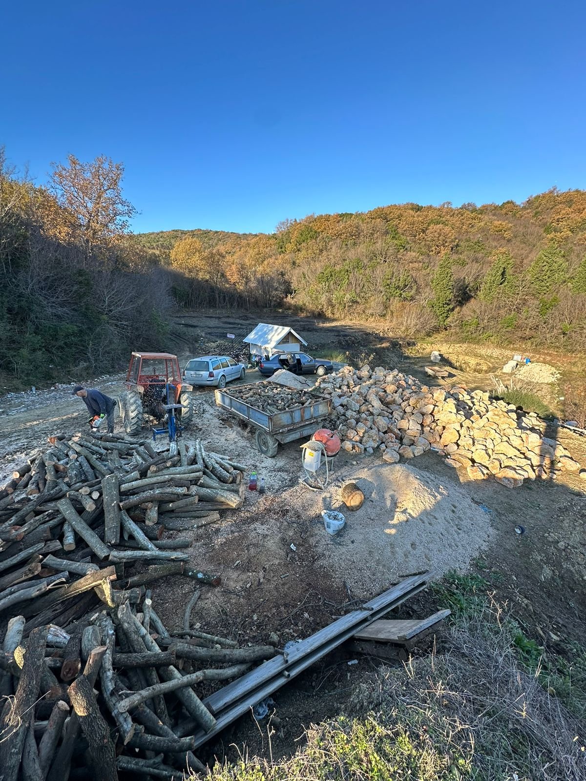 Prime eco-investment land in Ulcinj: spacious, tree-lined plot with work crews, logs, stones, and vehicles&mdash;exclusively at immorenta.me by ekosphere doo.