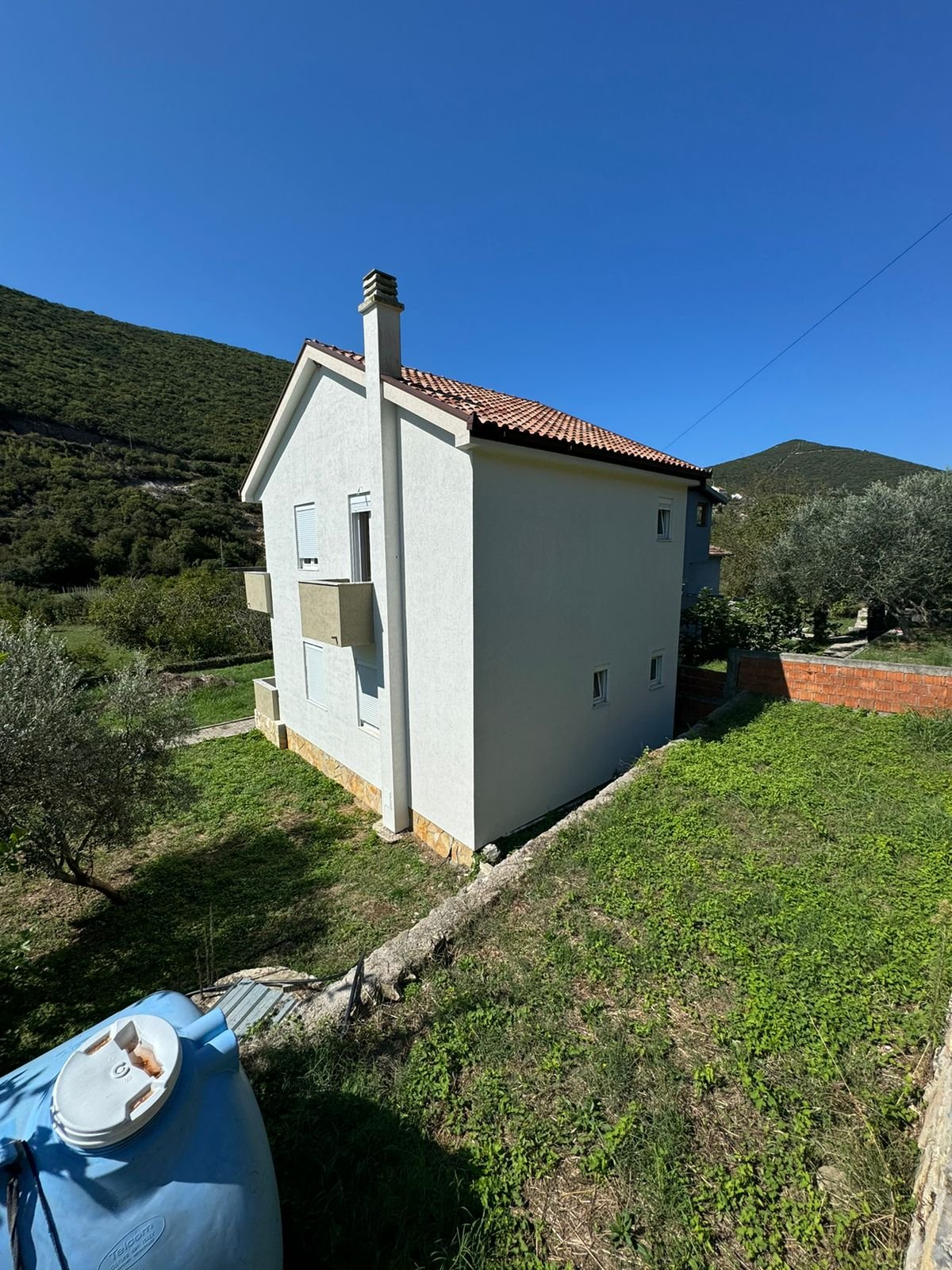 Modern white two-story house with red-tiled roof in Ulcinj, Montenegro&mdash;ideal investment listed on immorenta.me by Ekosphere.