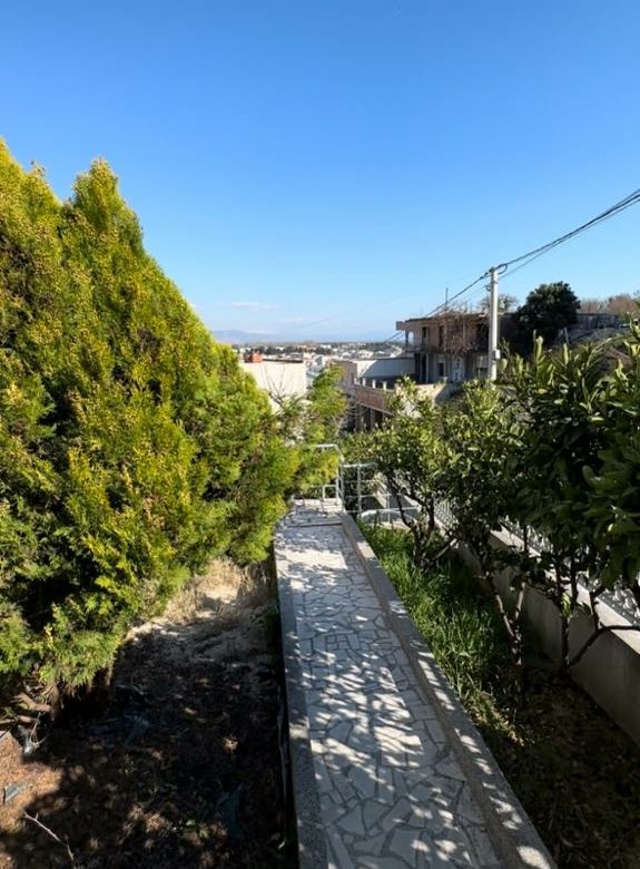 Scenic tiled path curves through lush greenery toward prime Ulcinj properties&mdash;exclusive on immorenta.me by ekosphere doo.