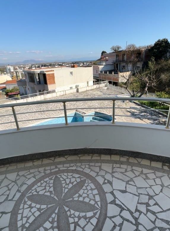 Modern balcony with flower mosaic tile flooring, street and building views in Ulcinj&mdash;prime real estate from ekosphere&rsquo;s immorenta.me.