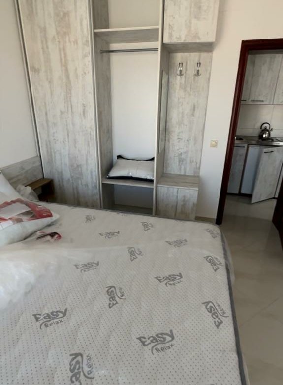 Modern Ulcinj bedroom with cozy bed, wardrobe, kitchen access&mdash;prime Montenegro real estate by ekosphere doo at immorenta.me.