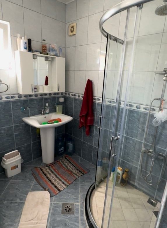 Modern Ulcinj bathroom with blue and white tiles, glass shower, sleek sink&mdash;prime real estate. Find more on immorenta.me by ekosphere doo.