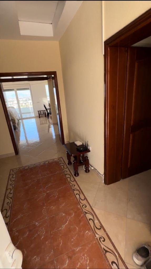 Bright hallway with beige walls and tile floors leads to a sunlit Ulcinj bedroom; ideal Montenegro property on immorenta.me by ekosphere doo.