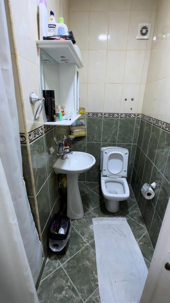 Modern Ulcinj property bathroom with elegant green and beige tiles, full amenities; exclusive at immorenta.me by ekosphere doo.