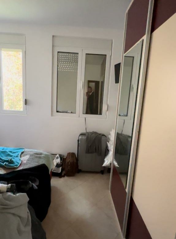 Charming Ulcinj bedroom with bed, mirrored wardrobe, and ample light&mdash;ideal Montenegro property investment on immorenta.me by ekosphere doo.