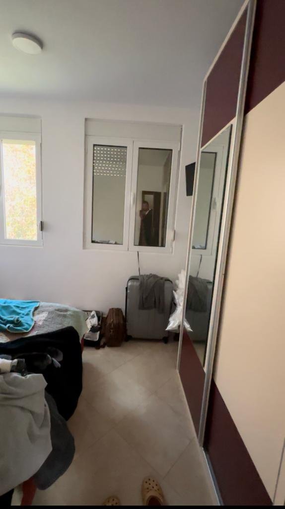 Charming Ulcinj bedroom with bed, mirrored wardrobe, and ample light&mdash;ideal Montenegro property investment on immorenta.me by ekosphere doo.