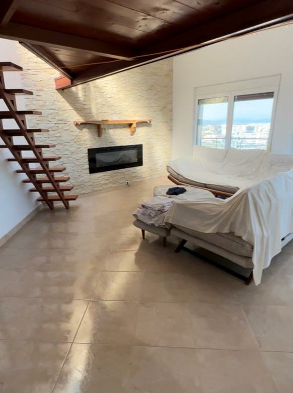 Luxury Ulcinj living room with stone accent wall, modern fireplace, floating stairs&mdash;exclusive on immorenta.me by ekosphere doo.