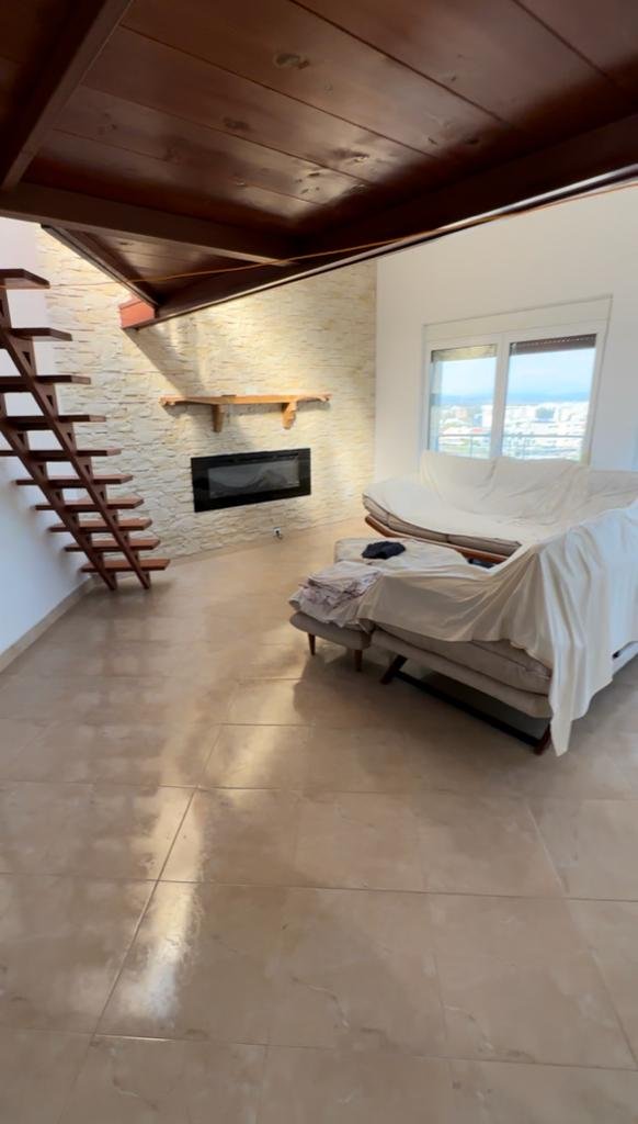 Luxury Ulcinj living room with stone accent wall, modern fireplace, floating stairs&mdash;exclusive on immorenta.me by ekosphere doo.