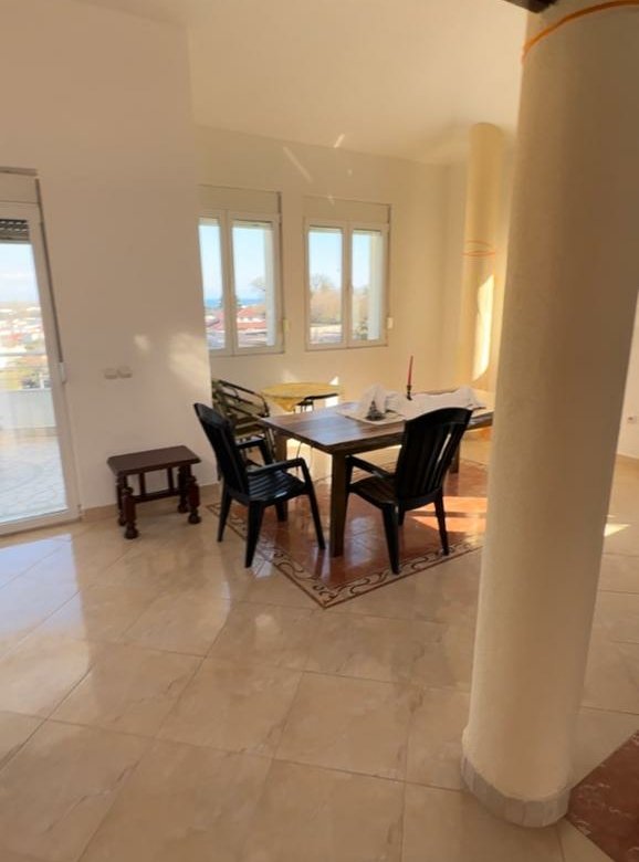 Bright dining area with tiled floors, modern furnishings, and sunlit windows&mdash;invest in Ulcinj Montenegro real estate at immorenta.me by ekosphere doo.