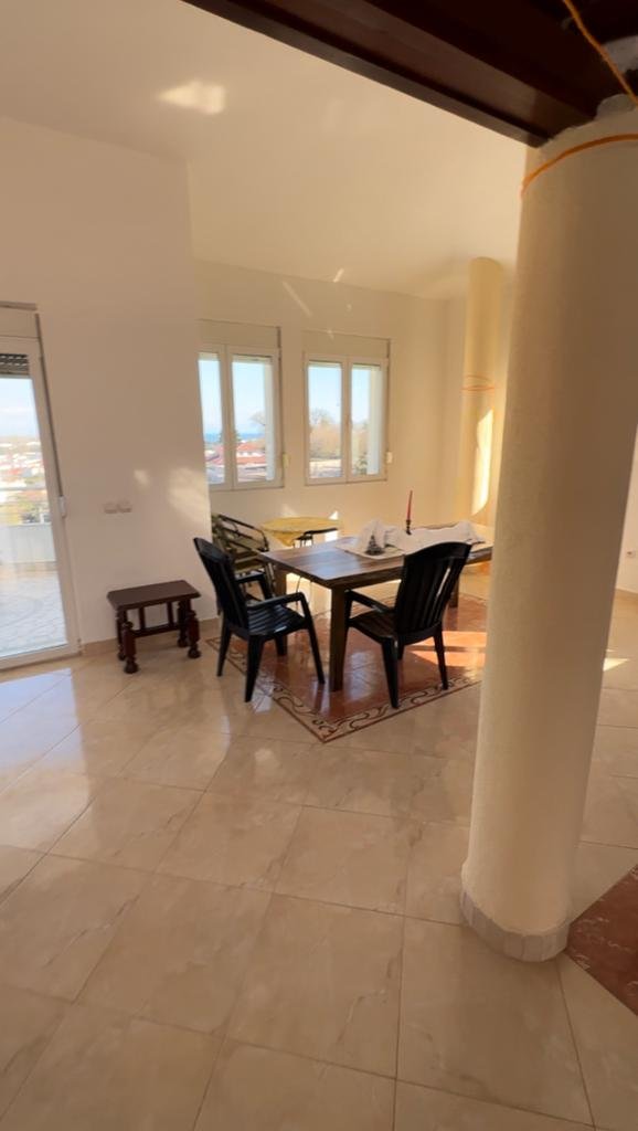Bright dining area with tiled floors, modern furnishings, and sunlit windows&mdash;invest in Ulcinj Montenegro real estate at immorenta.me by ekosphere doo.