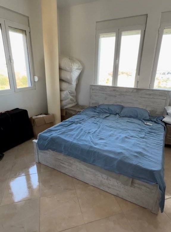 Invest in Ulcinj: spacious bedroom with double bed, blue linens, tiled floors, 3 large windows&mdash;exclusive on immorenta.me by ekosphere doo.