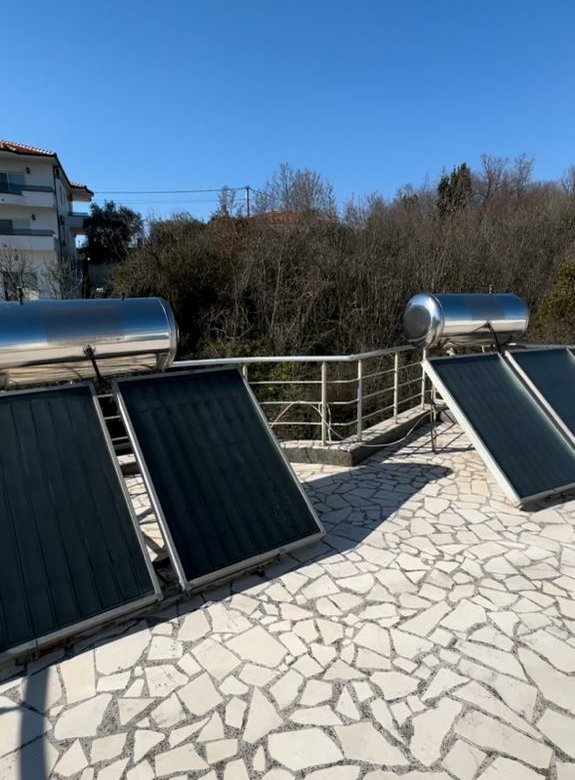 Modern solar water heaters on a tiled Ulcinj patio offer eco-investment appeal&mdash;exclusive at immorenta.me, by ekosphere doo.