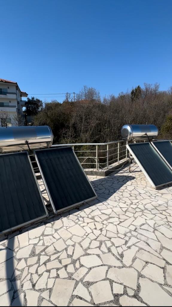 Modern solar water heaters on a tiled Ulcinj patio offer eco-investment appeal&mdash;exclusive at immorenta.me, by ekosphere doo.
