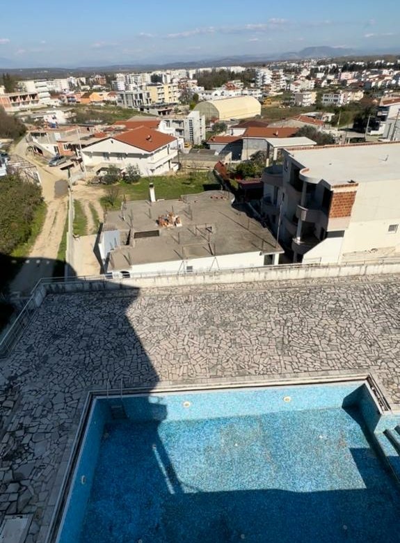 Prime Ulcinj real estate: aerial view of tiled pool, residential properties, cityscape&mdash;exclusive investment via immorenta.me.