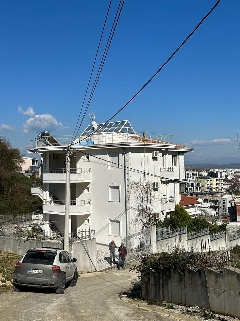 Modern three-story white property with balconies on a sloped street in Ulcinj, prime real estate by immorenta.me/Ekosphere.