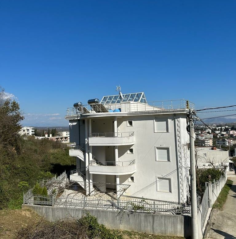 Modern four-story white building with balconies, solar panels, and lush greenery in Ulcinj&mdash;exclusive listing by ekosphere on immorenta.me.