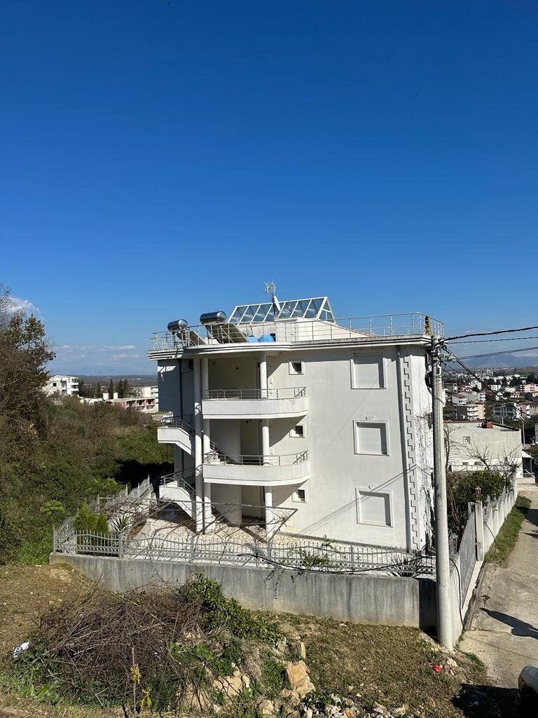 Modern four-story white building with balconies, solar panels, and lush greenery in Ulcinj&mdash;exclusive listing by ekosphere on immorenta.me.