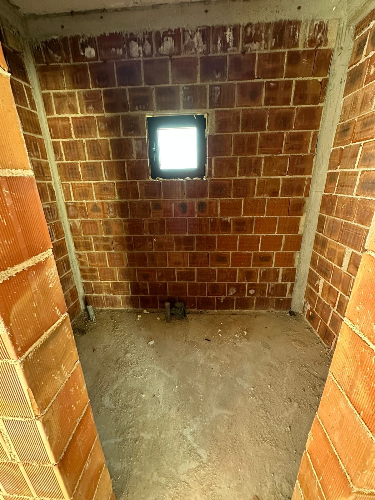 Unfinished room in Ulcinj, Montenegro with brick walls, concrete floor, and potential&mdash;exclusive at immorenta.me by Ekosphere doo.