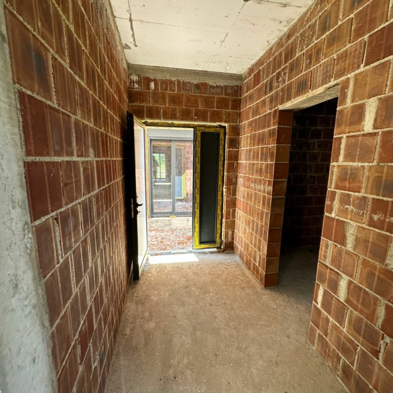 Bright, unfinished red brick space with dual open doorways&mdash;prime Ulcinj investment listed by immorenta.me (ekosphere doo).