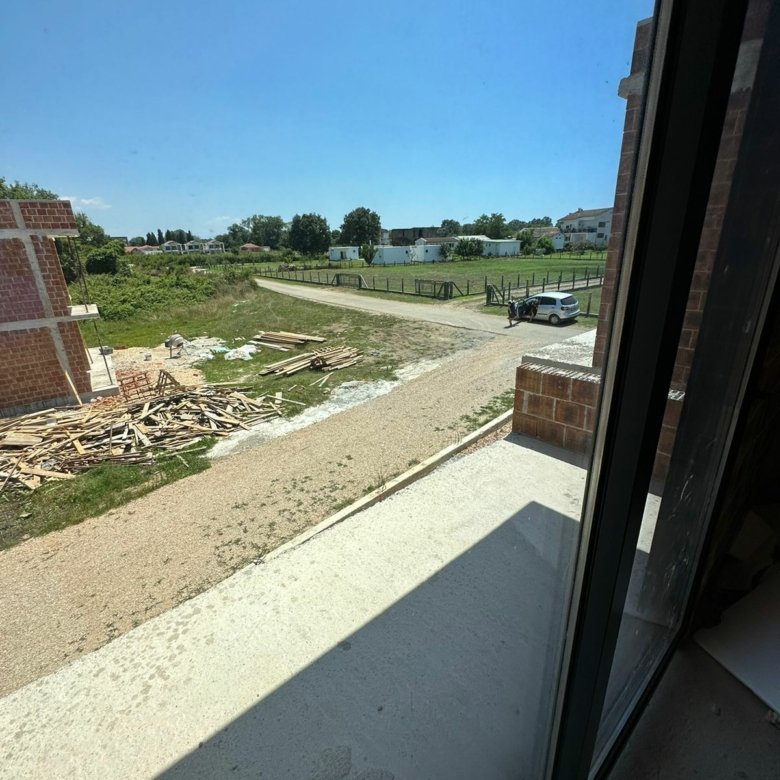 Panoramic Ulcinj, Montenegro property view: development site, road access, lush fields, and prime real estate. Eksosphere doo project.