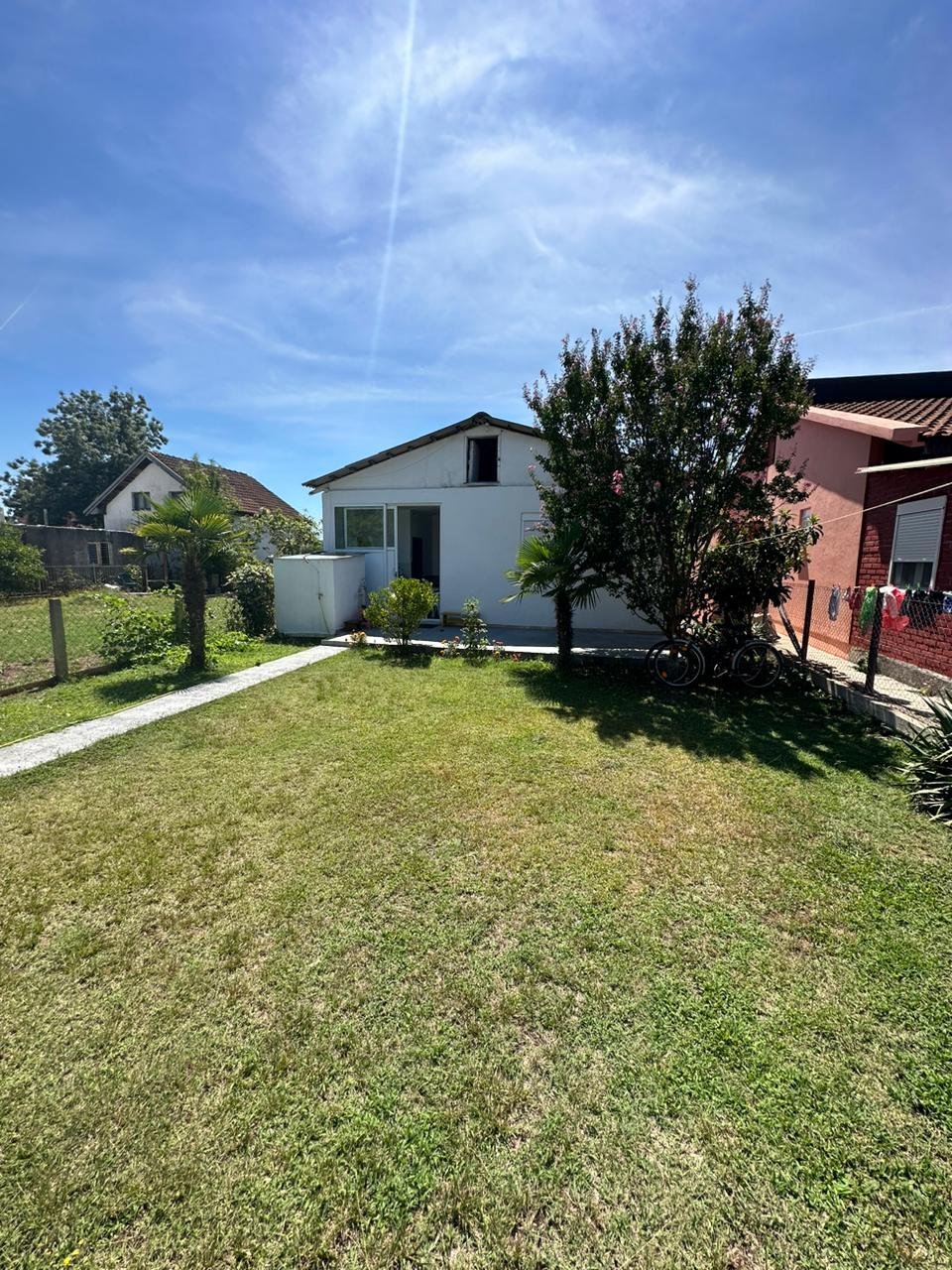 Charming white house with glass door on lush lawn, prime Ulcinj location near amenities&mdash;exclusive at immorenta.me by ekosphere doo.