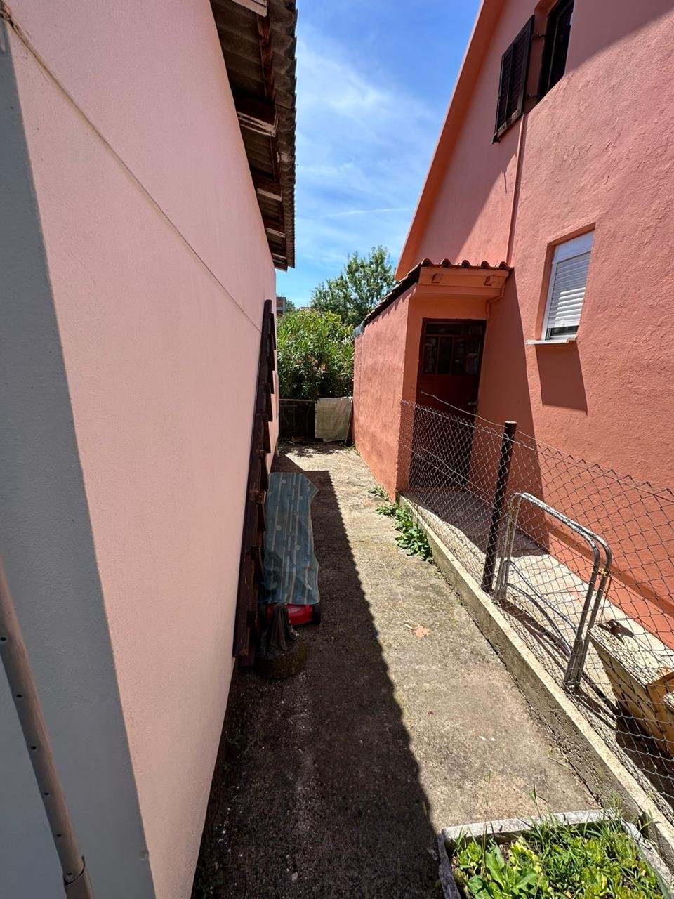 Charming Ulcinj investment: concrete pathway between pink properties, fenced garden. Exclusive on immorenta.me by ekosphere doo.
