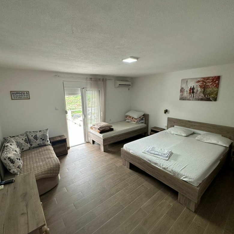 Bright, furnished Ulcinj bedroom with beds, sofa, desk & scenic views&mdash;prime investment via immorenta.me by Ekosphere Doo.