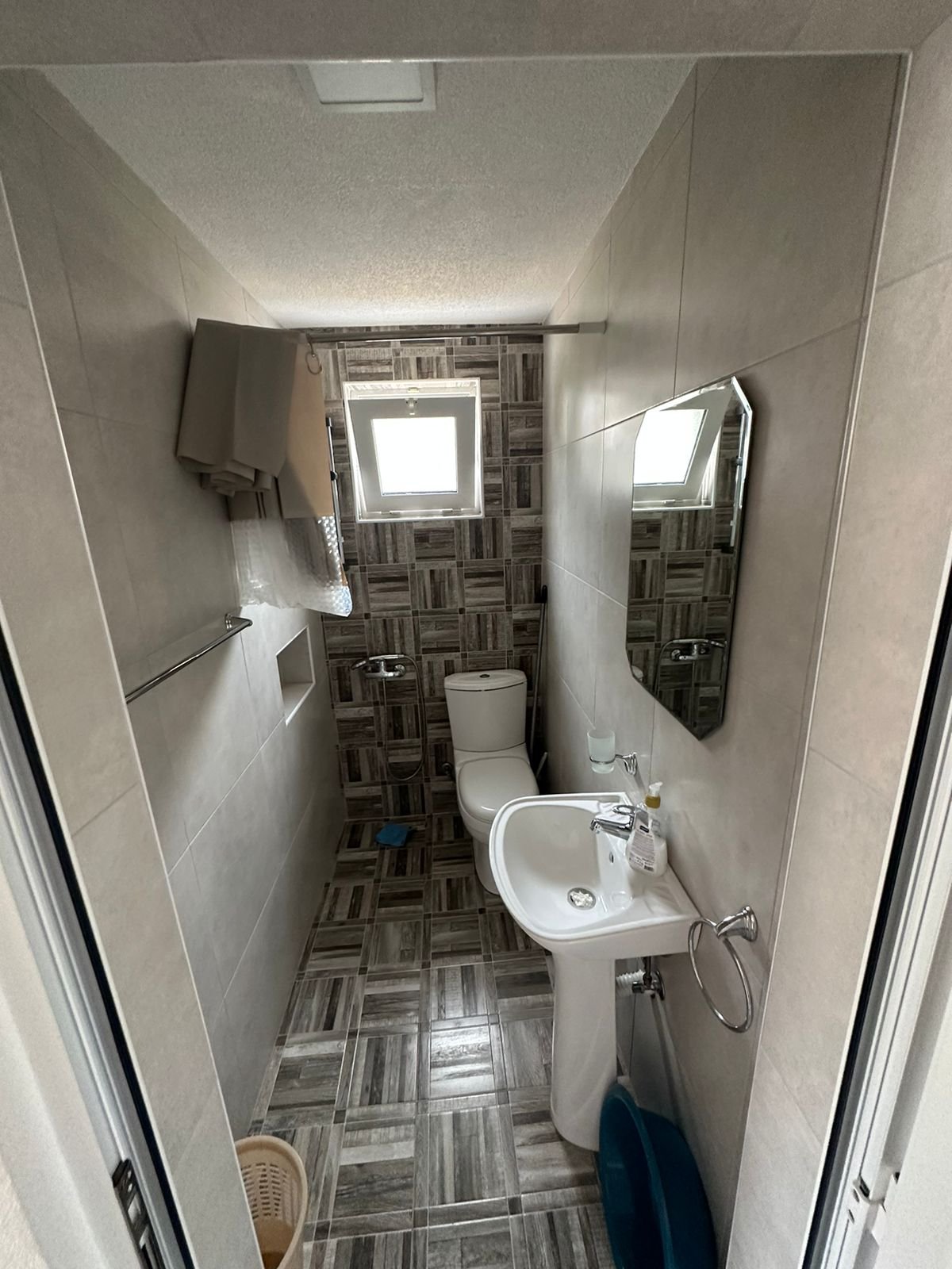 Modern tiled bathroom featuring natural light, quality fixtures, ideal for Ulcinj Montenegro real estate on immorenta.me by Ekosphere.