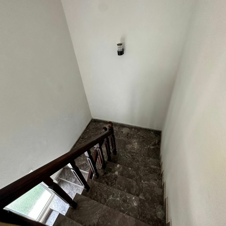 Elegant dark marble staircase with wood handrail in Ekosphere DOO Ulcinj property&mdash;ideal Montenegro investment via immorenta.me.