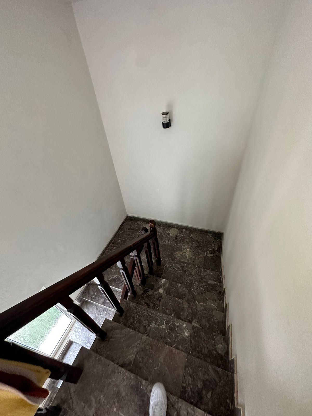 Elegant dark marble staircase with wood handrail in Ekosphere DOO Ulcinj property&mdash;ideal Montenegro investment via immorenta.me.