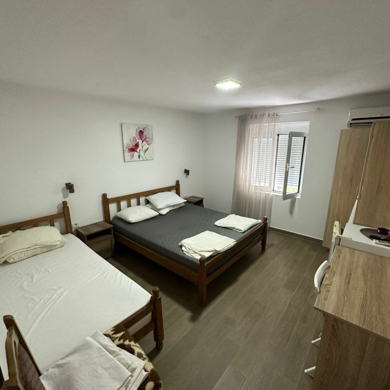 Bright Ulcinj bedroom with double & single bed, wardrobe, desk, window&mdash;prime investment via immorenta.me by Ekosphere.