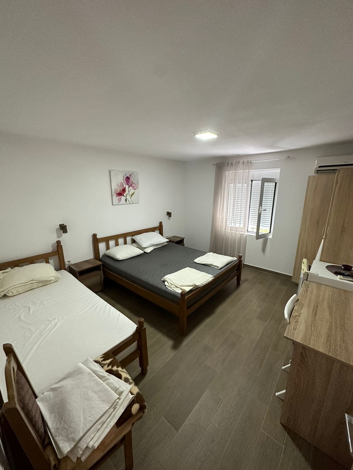 Bright Ulcinj bedroom with double & single bed, wardrobe, desk, window&mdash;prime investment via immorenta.me by Ekosphere.