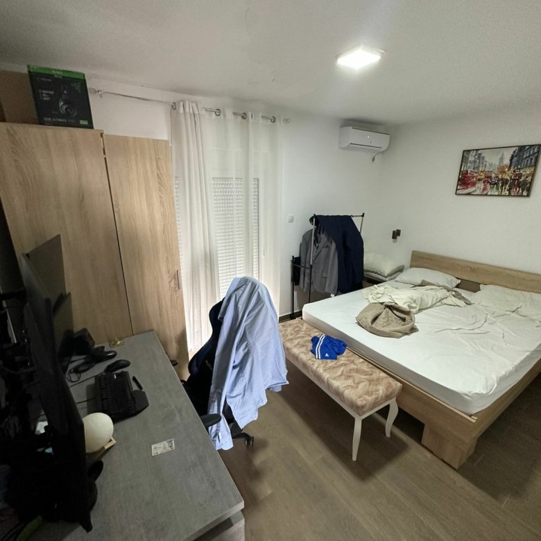 Bright Ulcinj bedroom with spacious bed, desk, wardrobe & sunlit curtains&mdash;prime property at immorenta.me by Ekosphere doo.