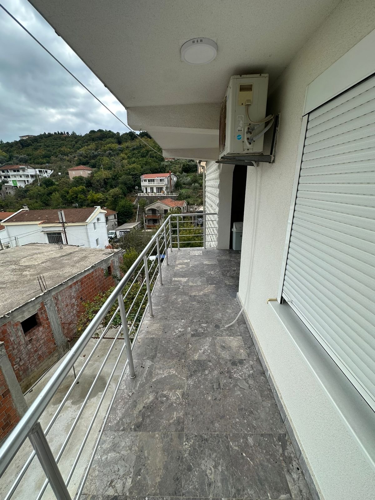 Stylish tiled balcony with metal railing, AC, and scenic Ulcinj views&mdash;ideal Montenegro investment via immorenta.me by ekosphere doo.