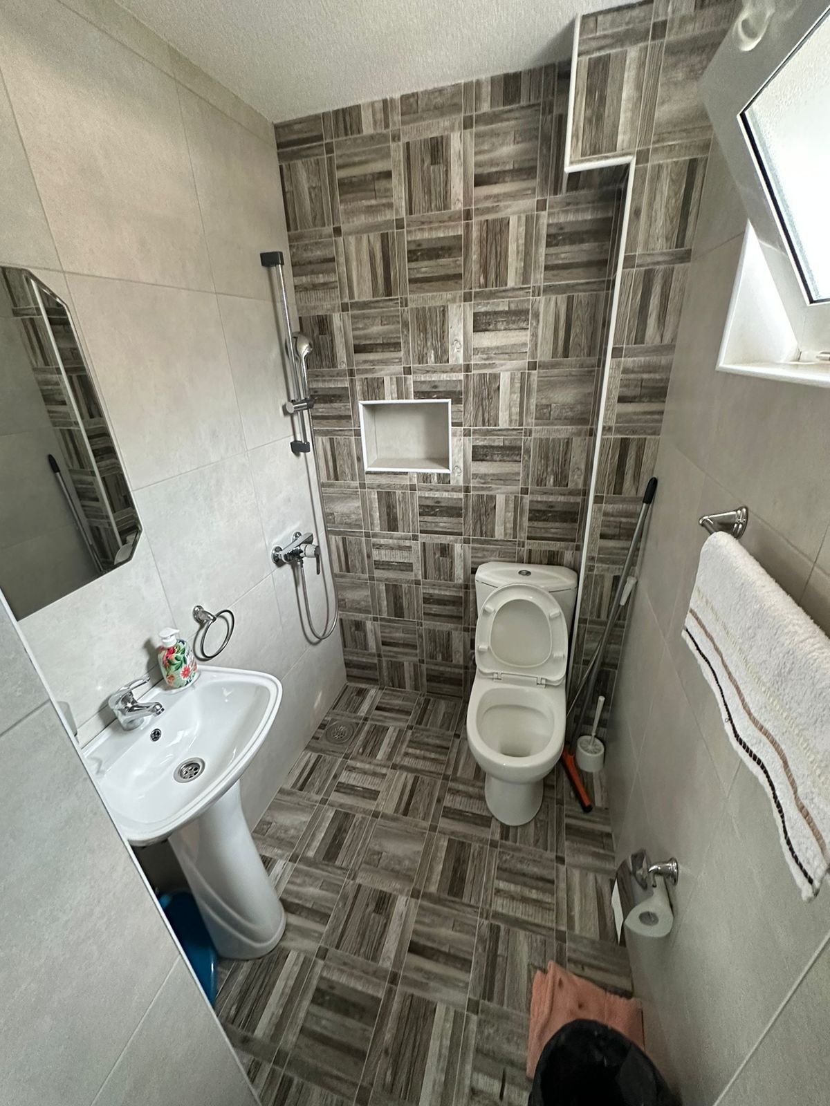 Modern bathroom in Ulcinj property with elegant tiles, shower, and amenities&mdash;exclusive listing on immorenta.me by ekosphere doo.
