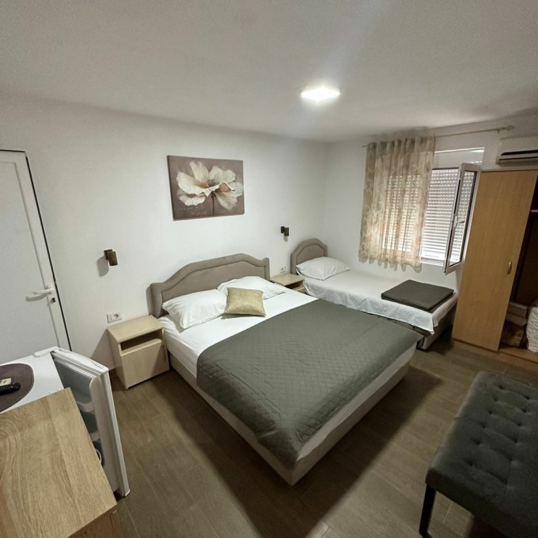 Modern hotel room in Ulcinj, Montenegro with double and single beds&mdash;ideal investment via immorenta.me by Ekosphere doo.