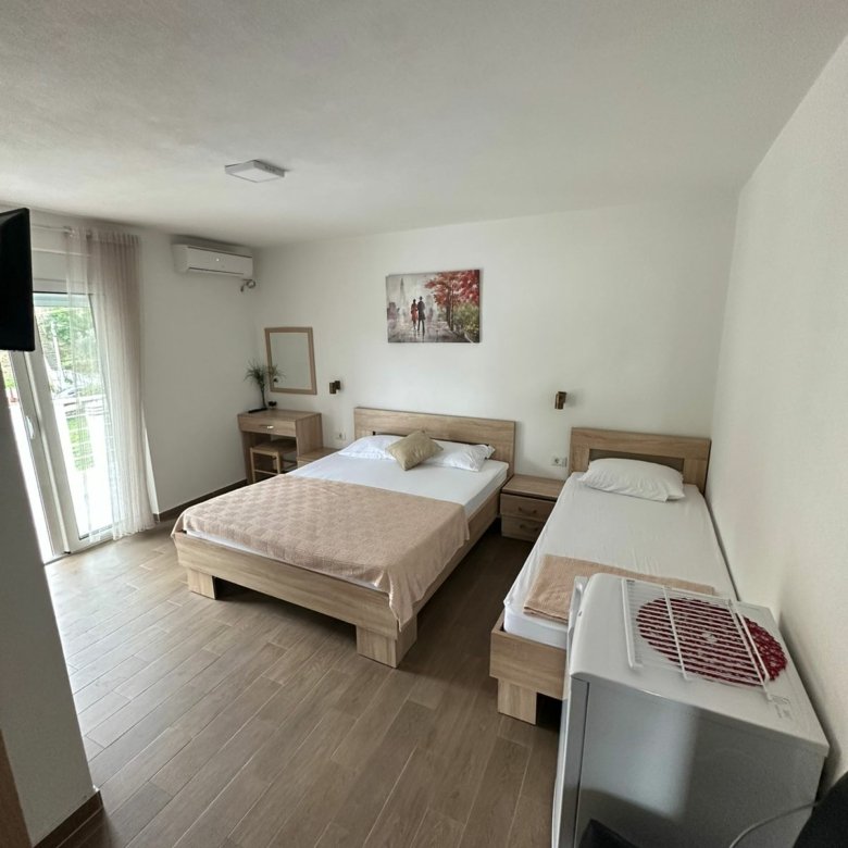 Modern Ulcinj hotel room with two beds, bright natural light, TV, fridge&mdash;prime investment. Ekosphere doo, immorenta.me.