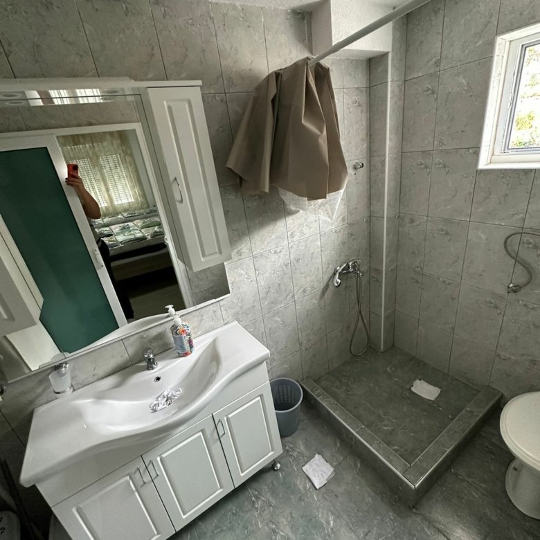 Bright tiled bathroom in Ulcinj with natural light, open shower, modern vanity&mdash;quality investment via immorenta.me by ekosphere doo.