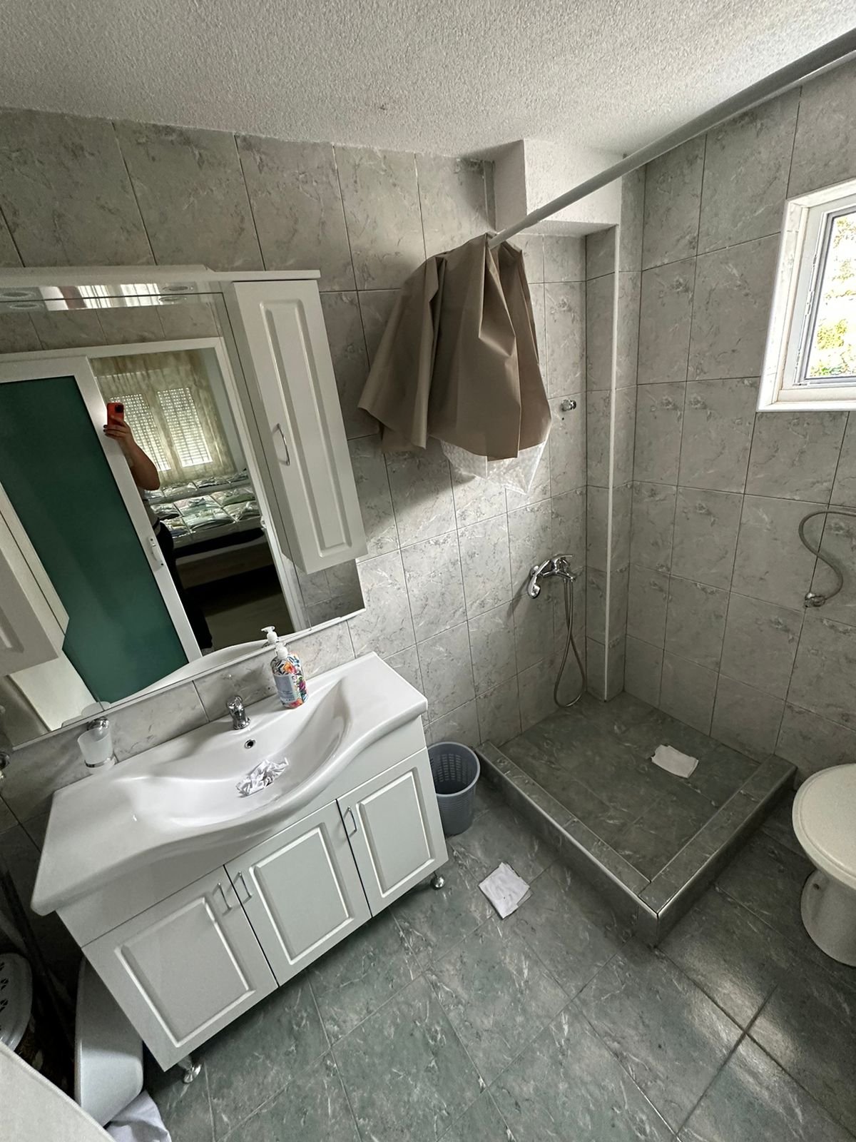 Bright tiled bathroom in Ulcinj with natural light, open shower, modern vanity&mdash;quality investment via immorenta.me by ekosphere doo.