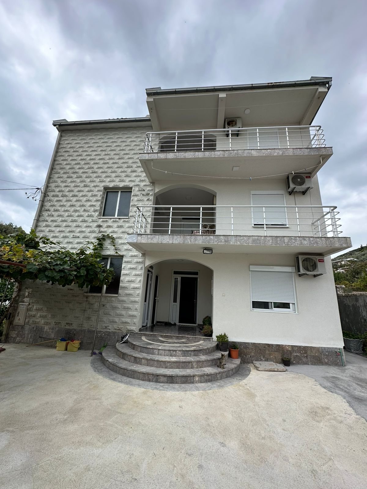 Modern three-story home in Ulcinj, Montenegro with balconies, AC units, and charming entry&mdash;ideal real estate by ekosphere doo.