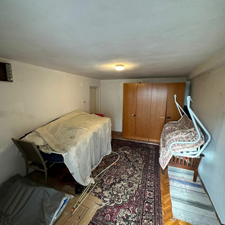 Charming Ulcinj property: compact room with white walls, wardrobe, sofa, unique features&mdash;exclusive on Montenegro-Listings by Ekosphere.
