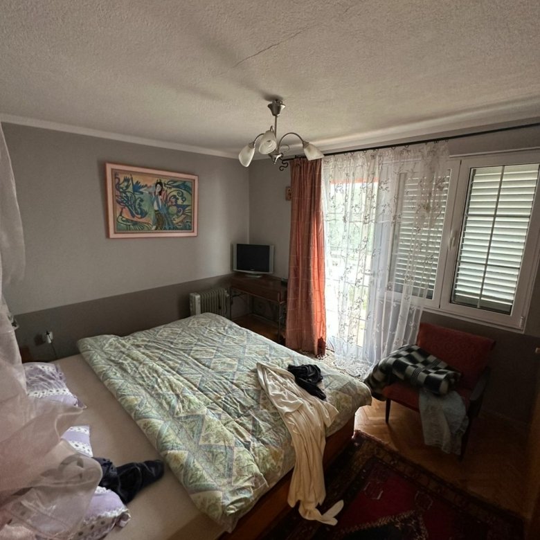 Spacious Ulcinj bedroom with large bed, natural light, modern TV, wood floors&mdash;exclusive at immorenta.me by Ekosphere doo.