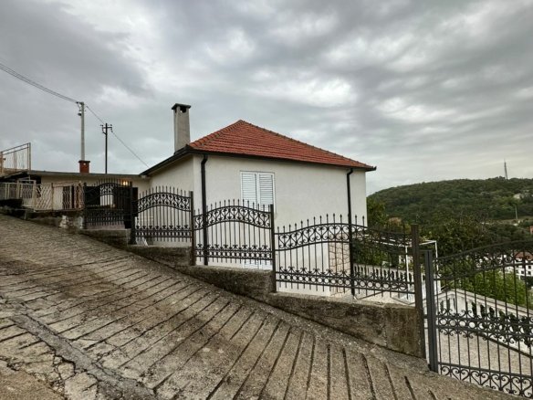 Charming white house with red roof, scenic green hills in Ulcinj&mdash;prime real estate by immorenta.me, an Ekosphere project.