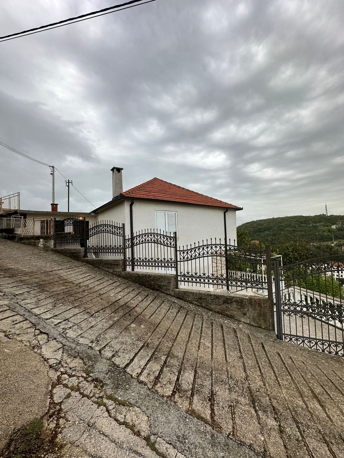 Charming white house with red roof, scenic green hills in Ulcinj&mdash;prime real estate by immorenta.me, an Ekosphere project.